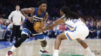 Thunder guard Cason Wallace (22) steals the ball away from Minnesota Timberwolves guard Anthony Edwards (5) during the second half at Paycom Center with Paul Pierce in the background