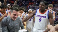 Florida head coach Todd Golden celebrates his 100th win and beating Mississippi State 108-77 with Florida center Rueben Chinyelu (9) and the rest of the team after an NCAA mens basketball game at Steven C. O'Connell Center Exactek arena in Gainesville, FL on Tuesday, March 3, 2026.