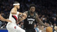 Minnesota Timberwolves forward Julius Randle (30) dribbles the ball as Portland Trail Blazers forward Toumani Camara (33) plays defense in the second half at Target Center.