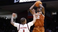 Texas Longhorns guard Tramon Mark (12) shoots the ball over NC State Wolfpack forward Darrion Williams (1) in the second half during a first four game of the men's 2026 NCAA Tournament at University of Dayton Arena.