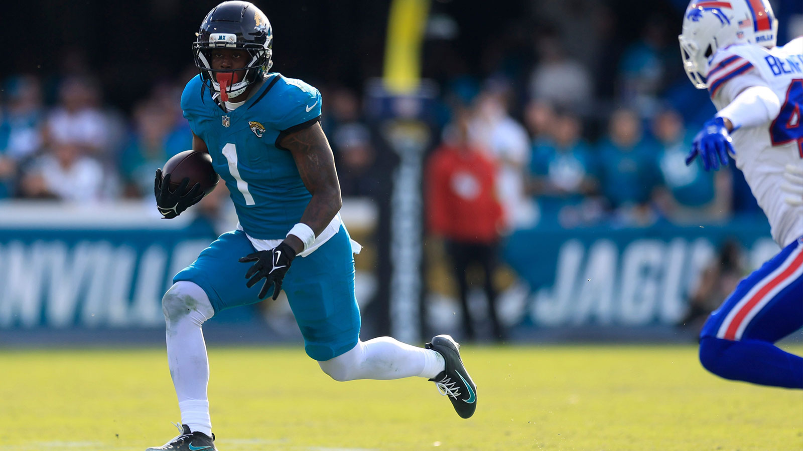 Jacksonville Jaguars running back Travis Etienne Jr. (1) rushes for yards during the third quarter of an NFL football AFC Wild Card playoff matchup, Sunday, Jan. 11, 2026, in Jacksonville, Fla. The Bills defeated the Jaguars 27-24. 
