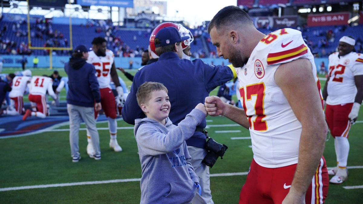 Kansas City Chiefs tight end Travis Kelce (87) greets Joey Borgonzi, 10, after their game at Nissan Stadium Sunday, Dec. 21, 2025. The Titans beat the Chiefs 26-9.