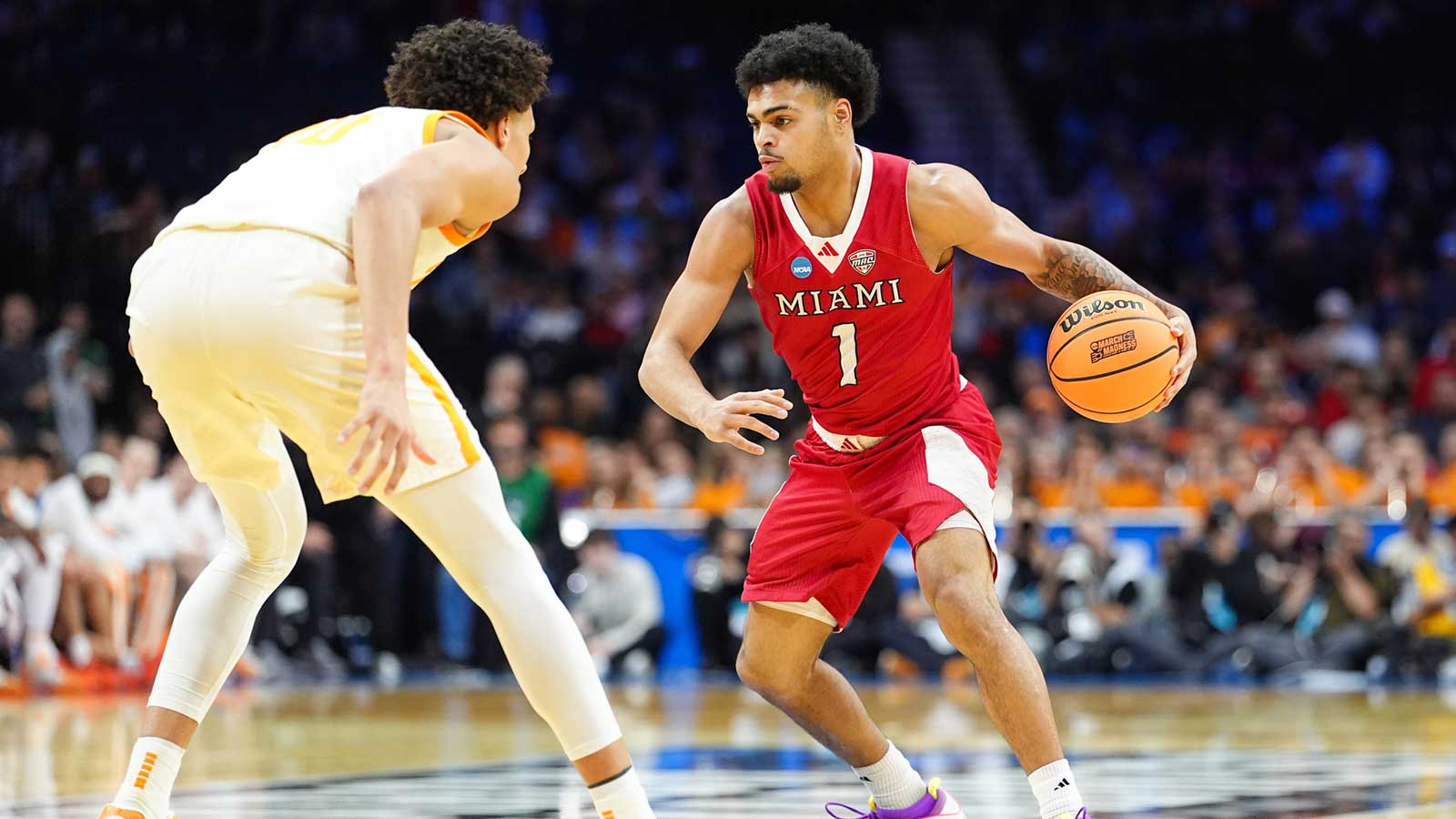 Miami (OH) RedHawks guard Trey Perry (1) drives against Tennessee Volunteers forward Nate Ament (10) during the second half during a first round game of the men's 2026 NCAA Tournament at Xfinity Mobile Arena.