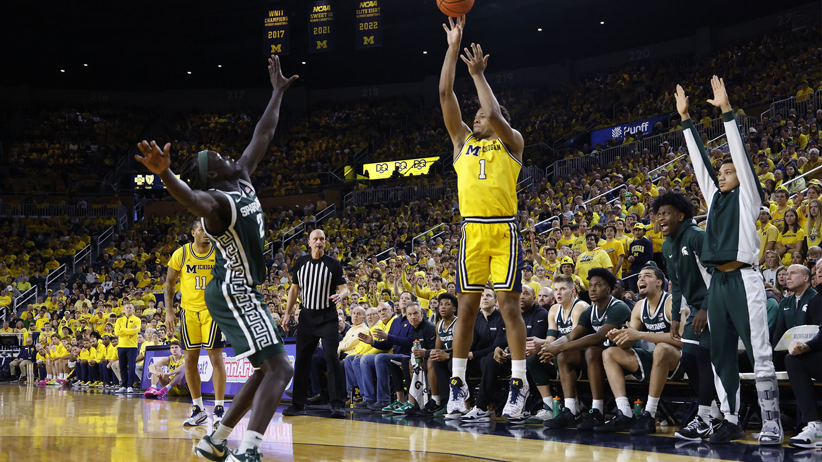 Michigan Wolverines guard Trey McKenney (1) shoots on Michigan State Spartans guard Kur Teng (2) in the first half at Crisler Center.