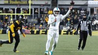 Miami Dolphins quarterback Tua Tagovailoa (1) throws a touchdown pass against the Pittsburgh Steelers during the fourth quarter at Acrisure Stadium.
