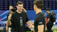 Indiana quarterback Fernando Mendoza (QB11) greets Alabama quarterback Ty Simpson (QB17) during the NFL Scouting Combine at Lucas Oil Stadium.