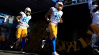 Los Angeles Chargers quarterback Justin Herbert (10) and tight end Tyler Conklin (83) enter the field before the first quarter of an NFL football game at EverBank Stadium, Sunday, Nov. 16, 2025 in Jacksonville, Fla. The Jacksonville Jaguars defeated the Los Angeles Chargers 35-6.