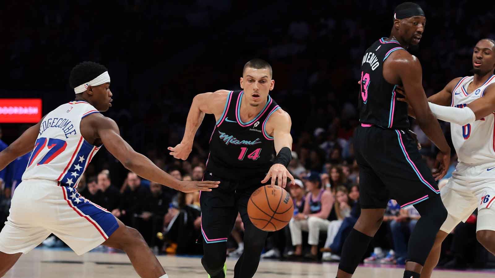 Miami Heat guard Tyler Herro (14) drives to the basket against Philadelphia 76ers guard Vj Edgecombe (77) during the first quarter at Kaseya Center. 