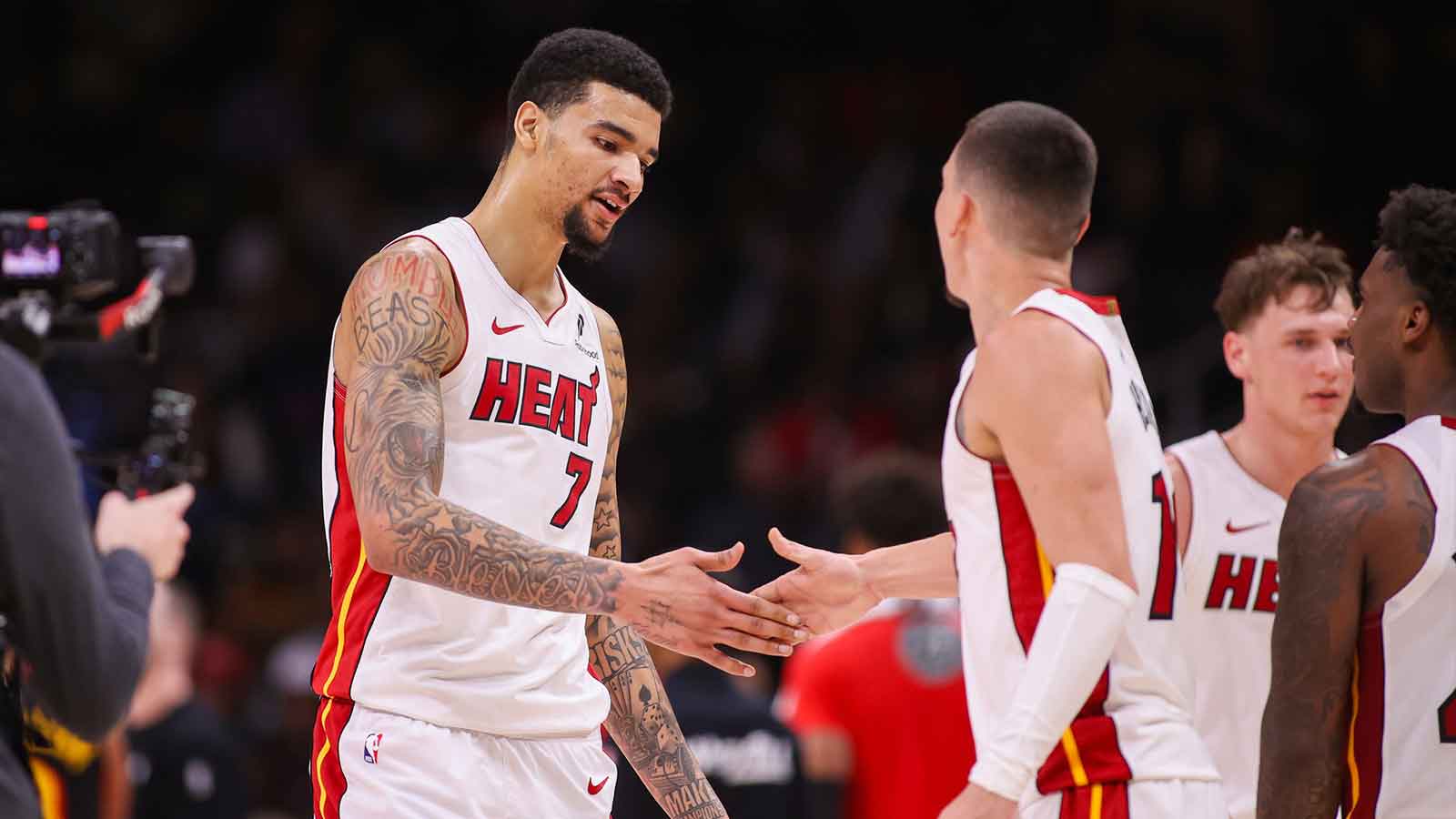Miami Heat center Kel'el Ware (7) celebrates with guard Tyler Herro (14) after a basket against the Atlanta Hawks in the fourth quarter at State Farm Arena. 