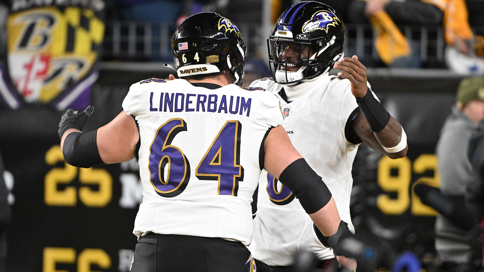Baltimore Ravens center Tyler Linderbaum (64) and Baltimore Ravens quarterback Lamar Jackson (8) react before the game at Acrisure Stadium. 