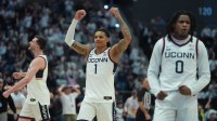 UConn Huskies guard Solo Ball (1), guard Malachi Smith (0) and forward Alex Karaban (11) react during a break against the St. John's Red Storm in the second half at PeoplesBank Arena.