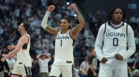 UConn Huskies guard Solo Ball (1), guard Malachi Smith (0) and forward Alex Karaban (11) react during a break against the St. John's Red Storm in the second half at PeoplesBank Arena.