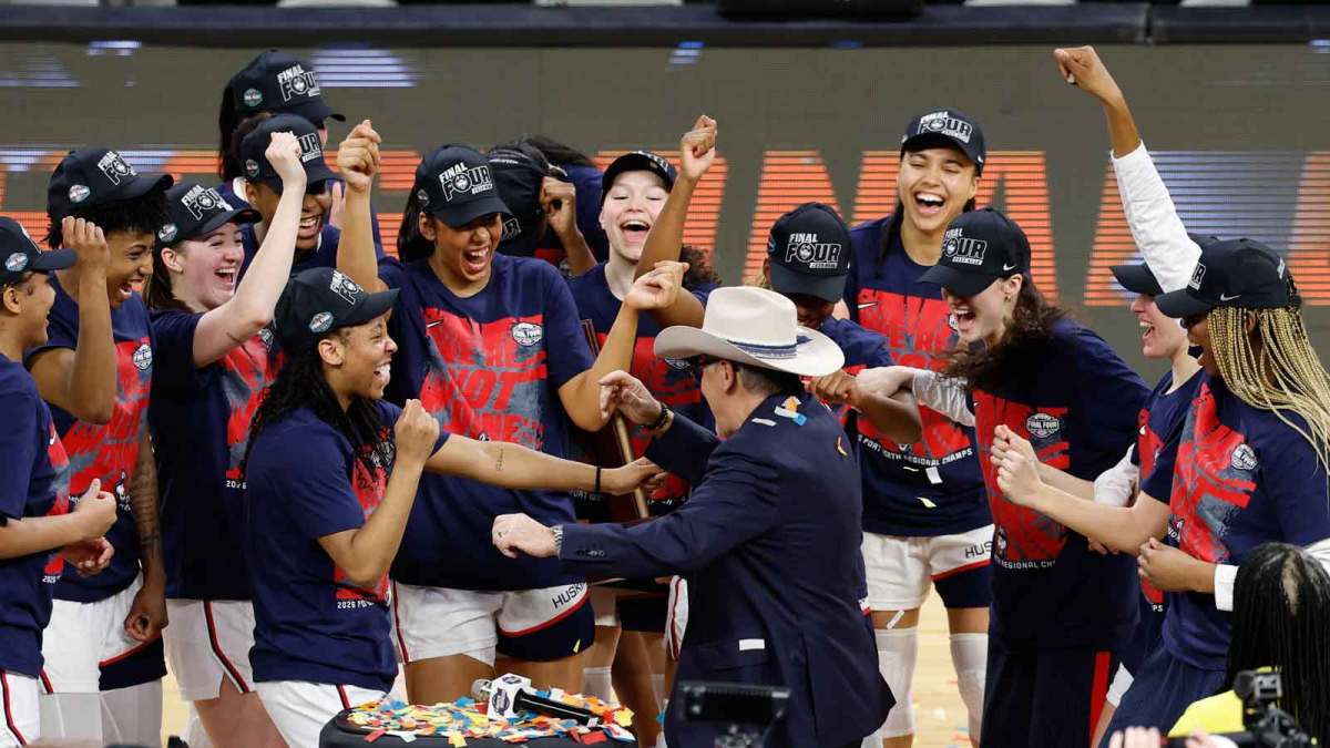 UConn Huskies head coach Geno Auriemma dances with his team after the UConn Huskies are awarded the Fort Worth Regional trophy following their win against the Notre Dame Fighting Irish at Dickies Arena.