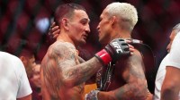 Max Holloway (red gloves) greets Charles Oliveira (blue gloves) after their fight during UFC 326 at T-Mobile Arena. Mandatory Credit: Stephen R. Sylvanie-Imagn Images
