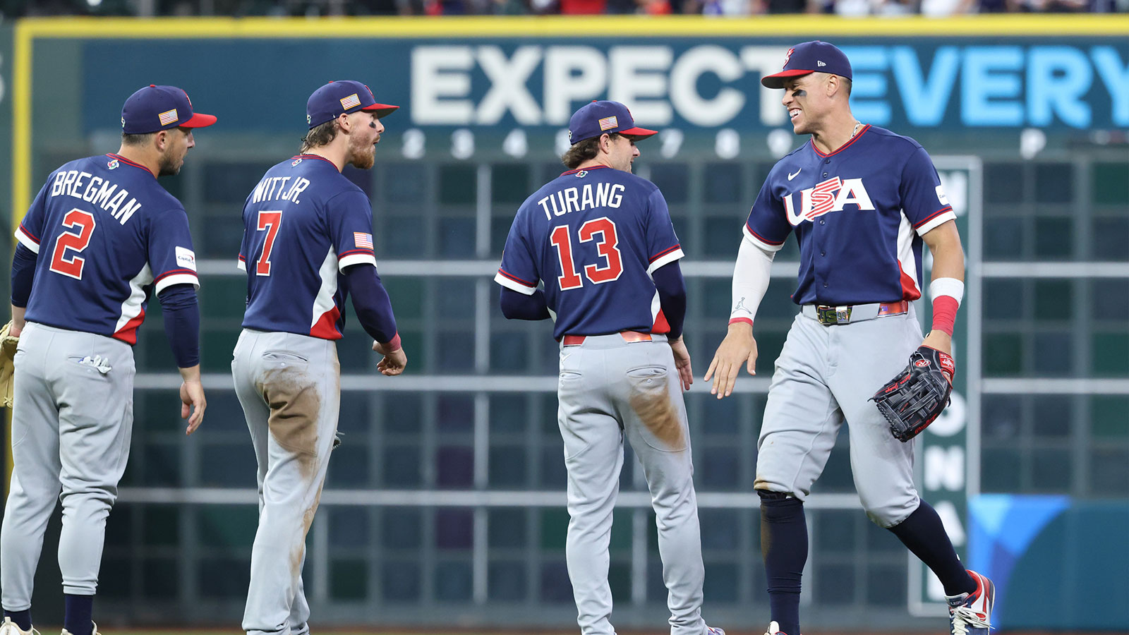 United States right fielder Aaron Judge (99), second baseman Brice Turang (13), shortstop Bobby Witt Jr. (7) and third baseman Alex Bregman (2) celebrate after defeating Canada during a quarterfinal game of the 2026 World Baseball Classic at Daikin Park.