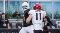 UCF Knights quarterback Jacurri Brown (11) looks to pass in front of Cincinnati Bearcats linebacker Jake Golday (11) during the second half at FBC Mortgage Stadium.