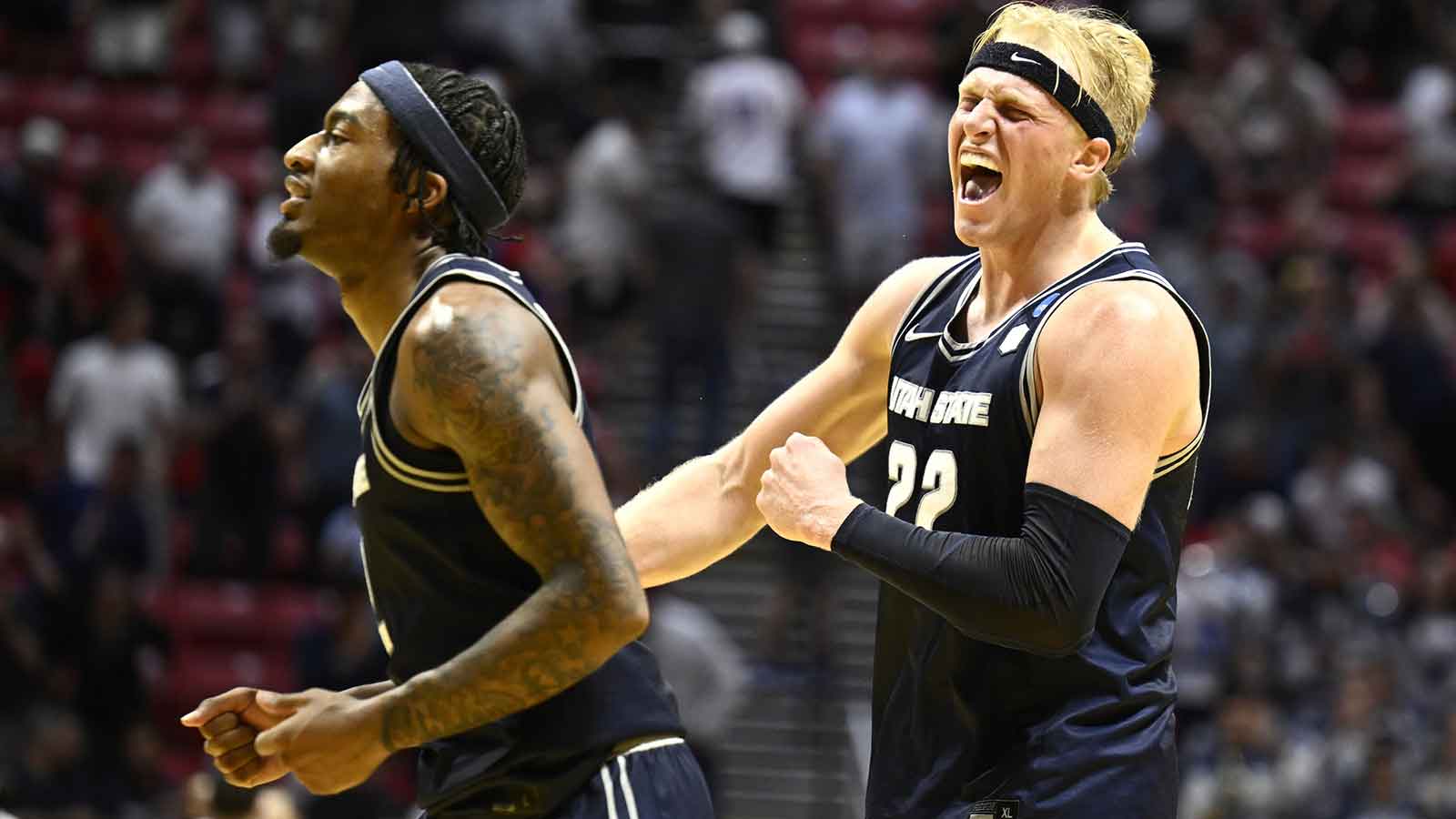 Utah State Aggies forward Karson Templin (22) and guard Mj Collins (2) celebrate in the second half against the Villanova Wildcats during a first round game of the men's 2026 NCAA Tournament at Viejas Arena.