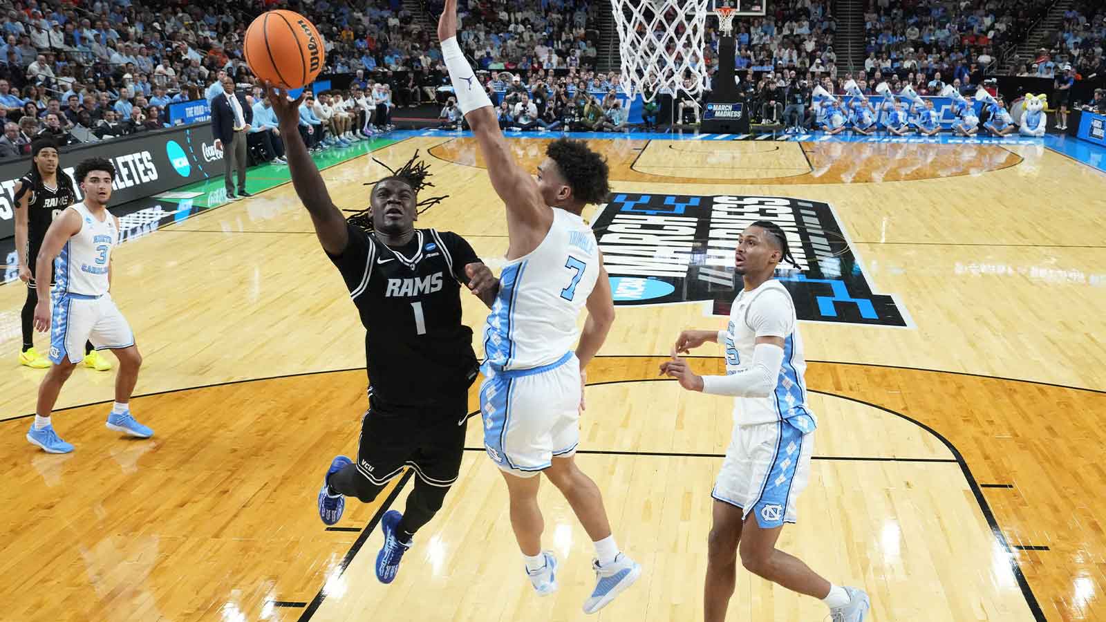 VCU Rams guard Nyk Lewis (1) goes to the basket against North Carolina Tar Heels guard Seth Trimble (7) in the second half of a first round game of the men's 2026 NCAA Tournament at Bon Secours Wellness Arena.
