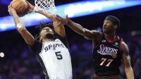 San Antonio Spurs guard Stephon Castle (5) drives for a shot against Philadelphia 76ers guard Vj Edgecombe (77) during the first quarter at Xfinity Mobile Arena.