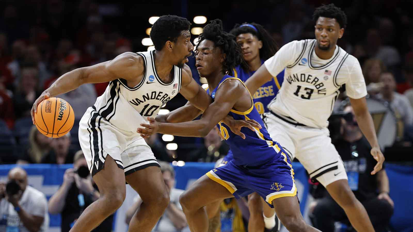 McNeese Cowboys forward Jacolb Fredson-Cole (10) drives to the hoop past McNeese Cowboys forward Peitok MacHar (15) during the second half during a first round game of the men's 2026 NCAA Tournament at Paycom Center. 