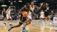 Vanderbilt Commodores guard Duke Miles (2) drives to the basket defended by Arkansas Razorbacks guard Meleek Thomas (1) in the second half during the men's SEC Conference Tournament Championship at Bridgestone Arena.