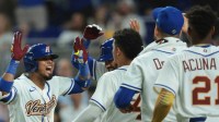 Venezuela first baseman Luis Arraez (2) celebrates with teammtes after hitting a home run against Israel during the fifth inning.