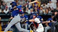 Venezuela third baseman Maikel Garcia (11) hits a sacrifice fly ball to score a run against the United States in the third inning during the 2026 World Baseball Classic Championship game at loanDepot Park