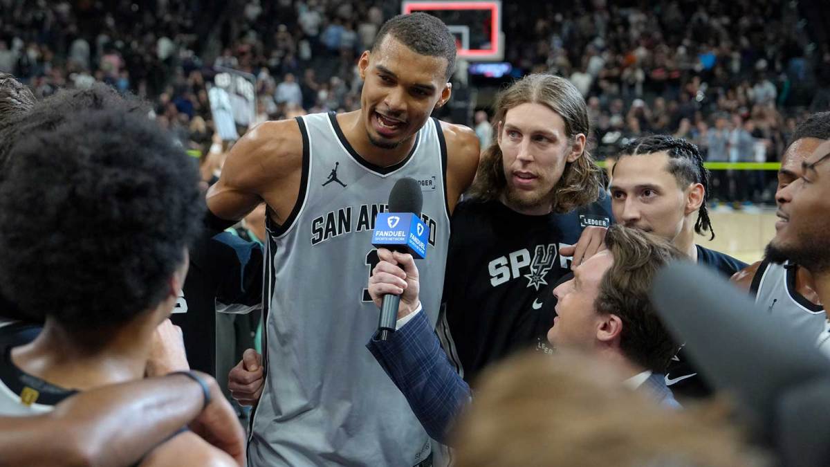 San Antonio Spurs forward Victor Wembanyama (1) gives an interview beside forward Kelly Olynyk (8) after the game against the Phoenix Suns at Frost Bank Center.