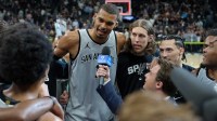 San Antonio Spurs forward Victor Wembanyama (1) gives an interview beside forward Kelly Olynyk (8) after the game against the Phoenix Suns at Frost Bank Center.