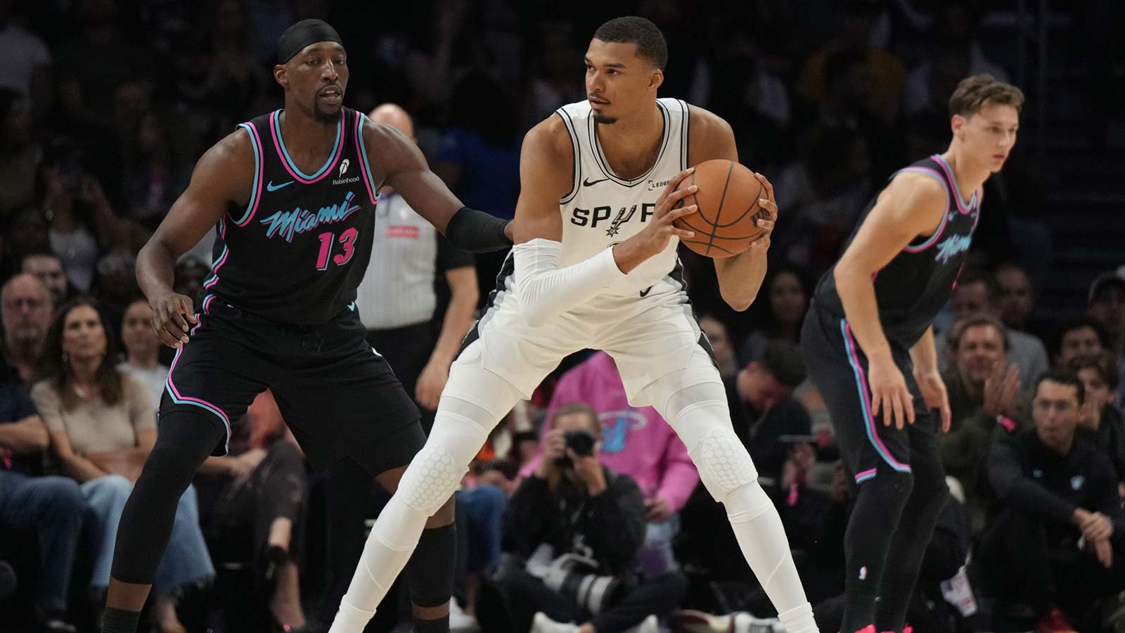 Miami Heat center Bam Adebayo (13) defends San Antonio Spurs forward Victor Wembanyama (1) during the first half at Kaseya Center.