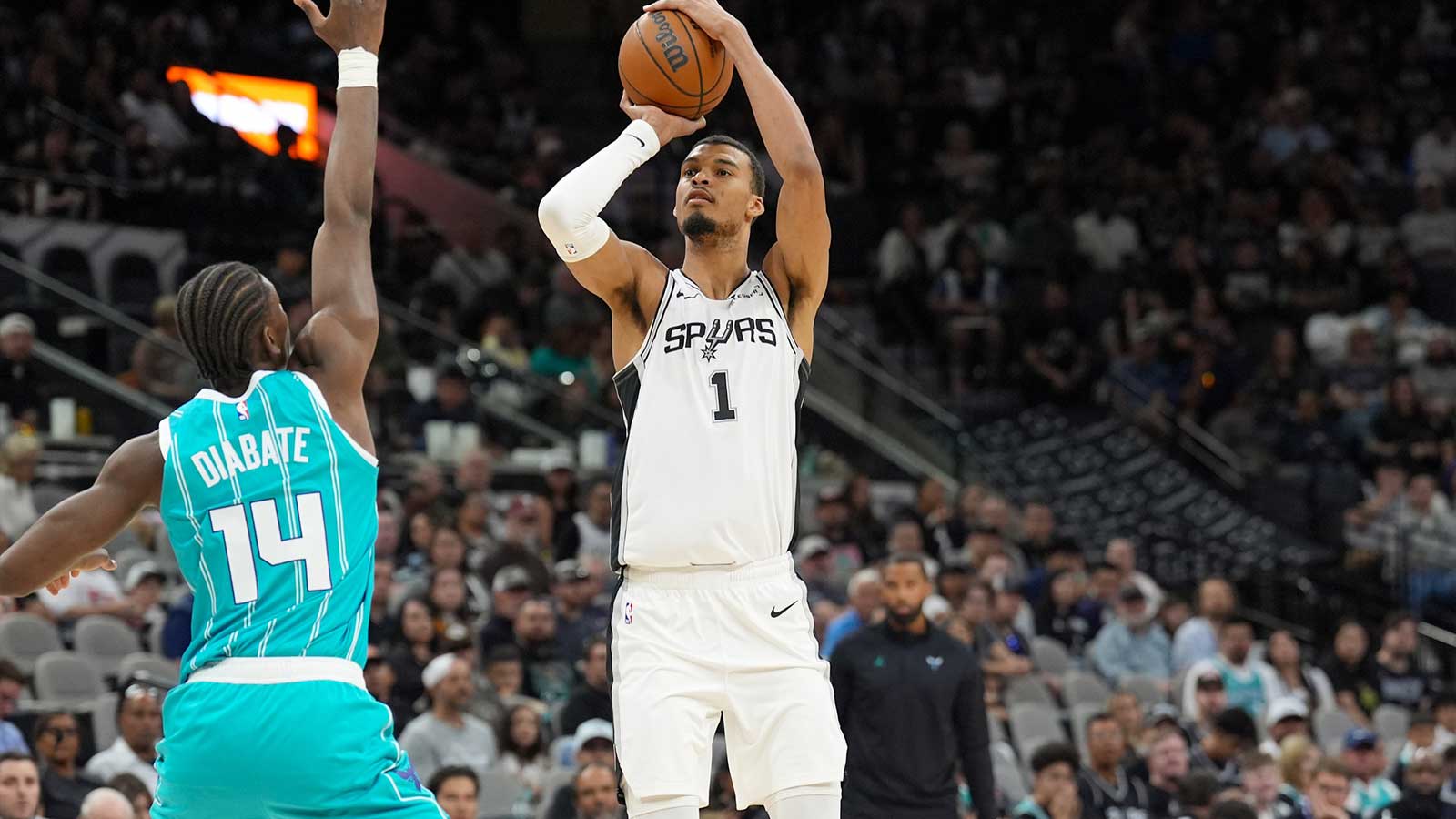 San Antonio Spurs forward Victor Wembanyama (1) shoots over Charlotte Hornets forward Moussa Diabate (14) in the second half at Frost Bank Center.