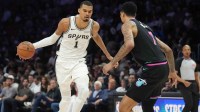 San Antonio Spurs forward Victor Wembanyama (1) drives to the basket as Miami Heat center Kel'el Ware (7) defends during the second half at Kaseya Center.