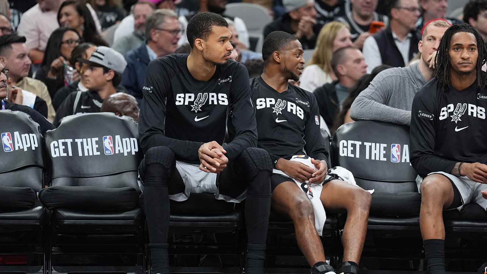 San Antonio Spurs forward Victor Wembanyama (1) and guard De'aaron Fox (4) on the bench in the second half against the Houston Rockets at Frost Bank Center.