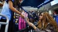 Injured Chicago Sky forward Angel Reese (5) signs autographs before a WNBA game against the New York Liberty.