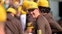 San Diego Padres pitcher Walker Buehler (10) looks on from the dugout in the fifth inning against the Milwaukee Brewers at Peoria Sports Complex.