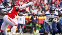 Seattle Seahawks running back Kenneth Walker III (9) runs the ball as Kansas City Chiefs linebacker Nick Bolton (32) defends during the second half at GEHA Field at Arrowhead Stadium.