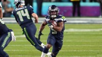 Seattle Seahawks running back Kenneth Walker III (9) carries the ball against the New England Patriots during the fourth quarter in Super Bowl LX at Levi's Stadium.