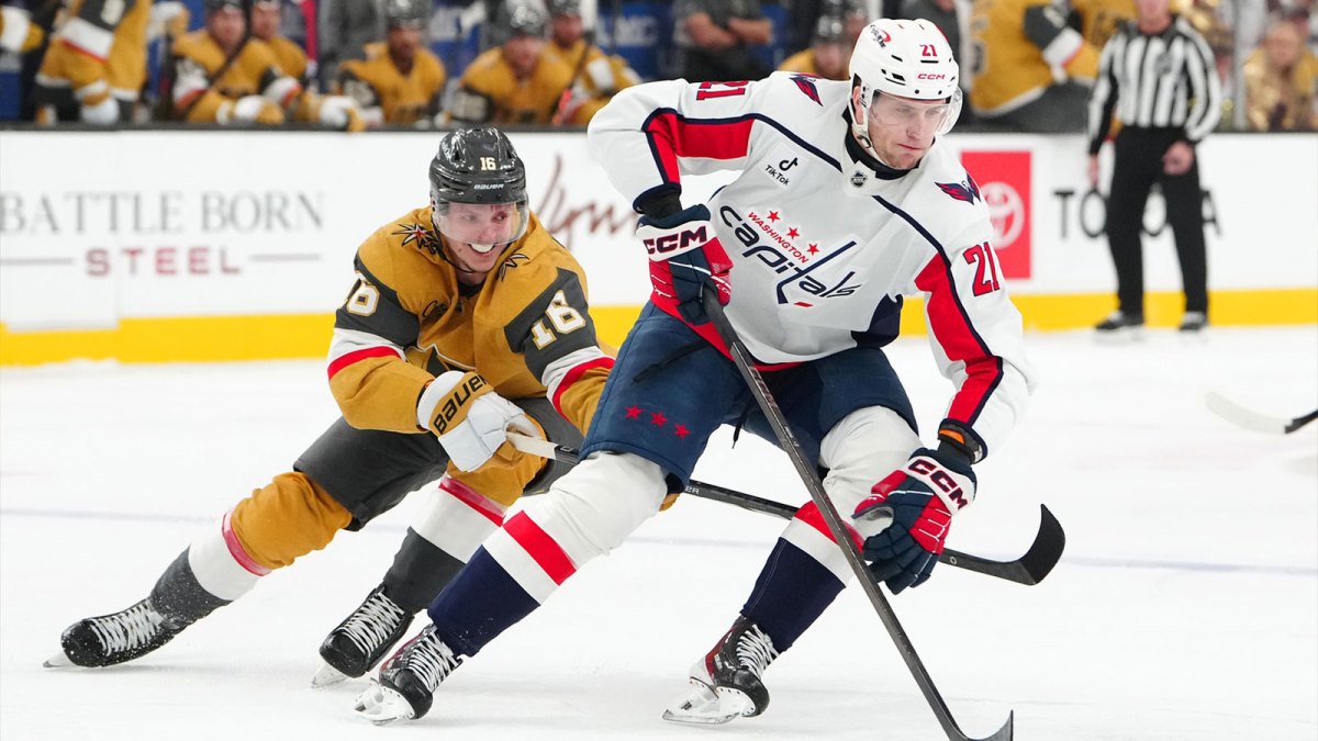 Washington Capitals left wing Aliaksei Protas (21) protects the puck from Vegas Golden Knights right wing Pavel Dorofeyev (16) during the first period at T-Mobile Arena.