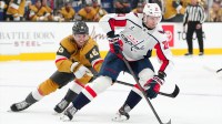 Washington Capitals left wing Aliaksei Protas (21) protects the puck from Vegas Golden Knights right wing Pavel Dorofeyev (16) during the first period at T-Mobile Arena.