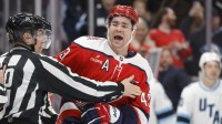 Washington Capitals right wing Tom Wilson (43) exchanges words with Utah Mammoth defenseman Mikhail Sergachev (98) after the third period at Capital One Arena.