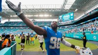 Los Angeles Chargers linebacker Odafe Oweh (98) celebrates with fans after the game against the Miami Dolphins at Hard Rock Stadium.