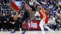 Detroit Pistons center Jalen Duren (0) dribbles defended by Atlanta Hawks forward Onyeka Okongwu (17) in the first half at Little Caesars Arena.