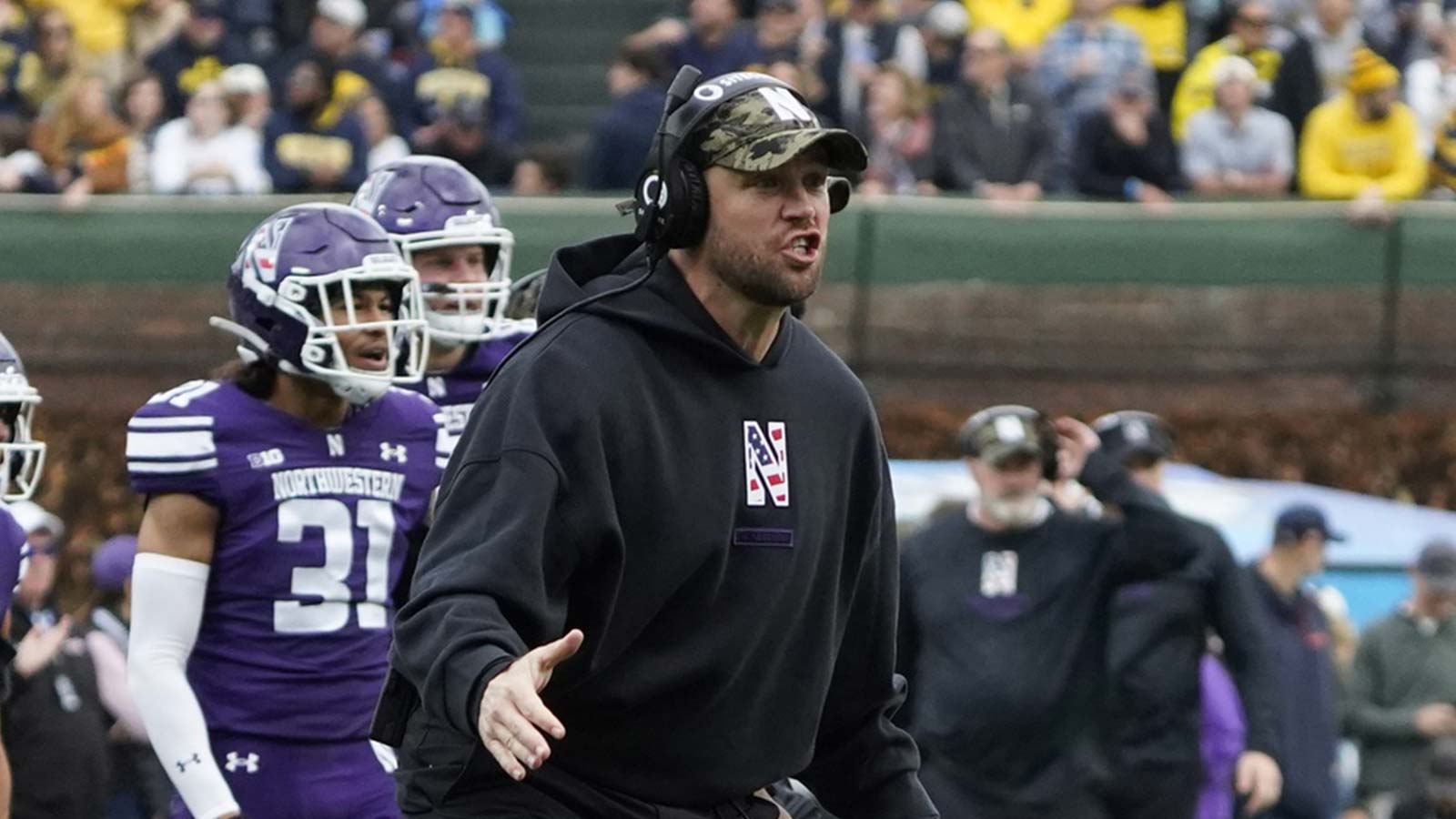 Northwestern Wildcats head coach David Braun gestures to his team against the Michigan Wolverines during the first half at Wrigley Field.