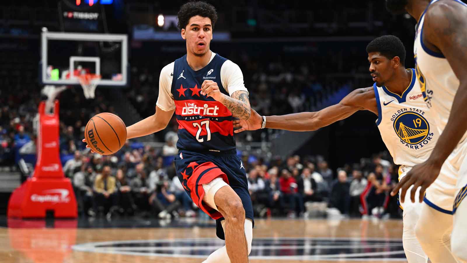 Washington Wizards guard Will Riley (27) dribbles as Golden State Warriors guard Nate Williams (19) during the first half at Capital One Arena.