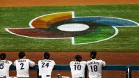 Team Japan watches the game from the dugout against the USA in the first inning at LoanDepot Park.