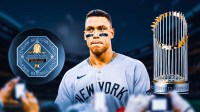 Aaron Judge with Yankees in middle. AL MVP trophy on right. World Series trophy on left