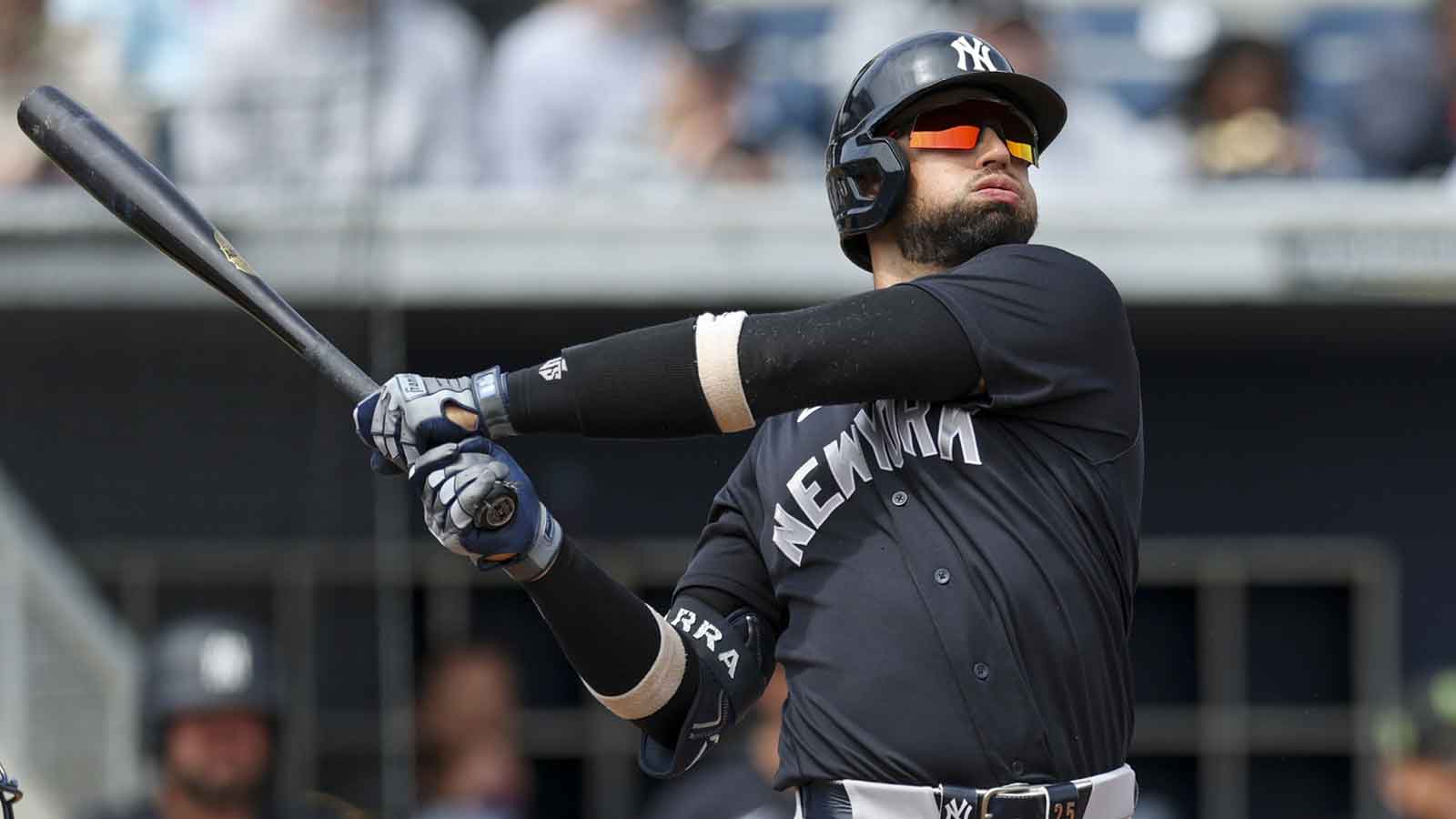 New York Yankees catcher J.C. Escarra (25) hits a home run against the Tampa Bay Rays in the second inning during spring training at Charlotte Sports Park.
