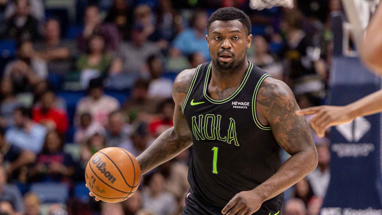 New Orleans Pelicans forward Zion Williamson (1) brings the ball up court against the Toronto Raptors during the first half at Smoothie King Center. 