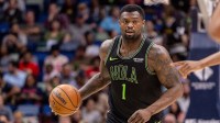 New Orleans Pelicans forward Zion Williamson (1) brings the ball up court against the Toronto Raptors during the first half at Smoothie King Center.