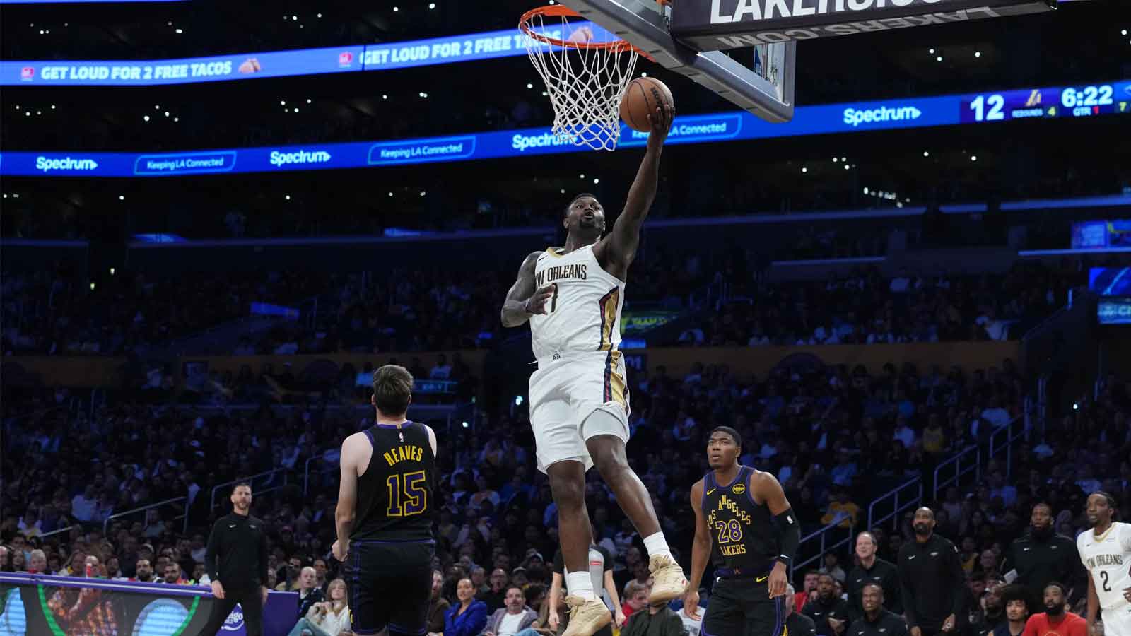 New Orleans Pelicans forward Zion Williamson (1) shoots the ball against Los Angeles Lakers guard Austin Reaves (15) and forward Rui Hachimura (28) in the first half at Crypto.com Arena.